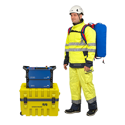 Field technician equipped with OMICRON CPX 200 backpack and testing gear, ready for high and medium voltage diagnostics in demanding environments.