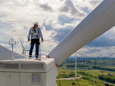 Windmill,Engineer,Wearing,Ppe,Standing,On,Wind,Turbine Windmill,Engineer,Wearing,Ppe,Standing,On,Wind,Turbine