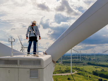 Windmill,Engineer,Wearing,Ppe,Standing,On,Wind,Turbine